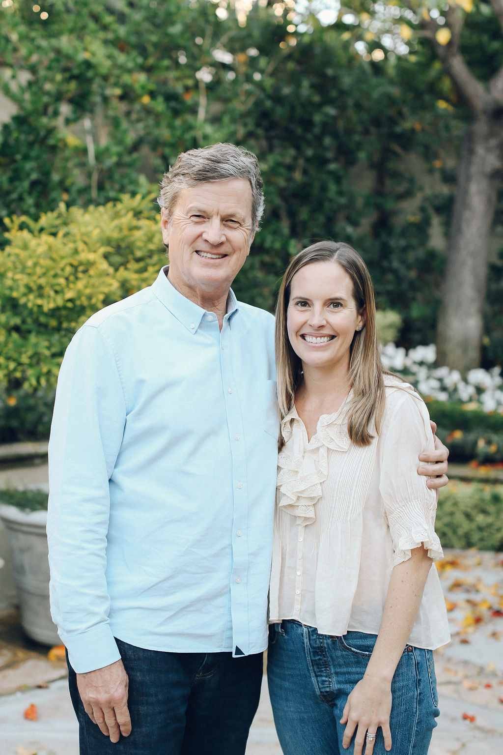 Scott Ramser and Ally Young standing together in a garden, smiling.